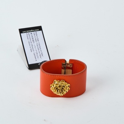 A Hugo Boss Orange Leather Bracelet with Gold Flower