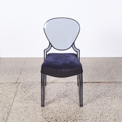 A Dark Tinted Ghost Style Chair with Plush Upholstery