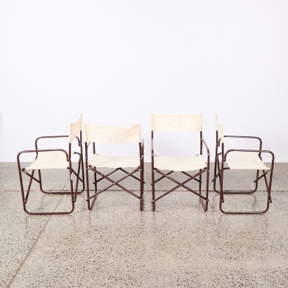 A Set Of Four Brown Foldable Deck Chairs With Linen Covers