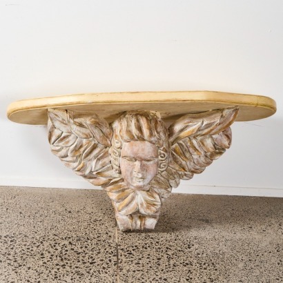 A Large French Carved Cherub Head Shelf