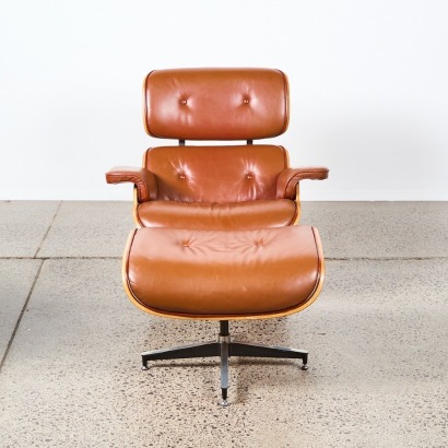 A Tan Eames Replica Chair and Footstool