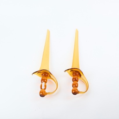 A Pair of Decorative Amber Glass Swords