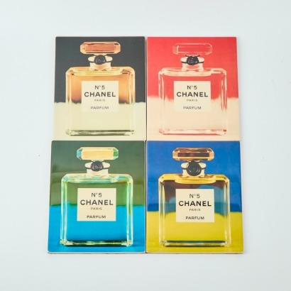 A Set of Four John Fairchild Chanel No. 5 Ceramic Tiles