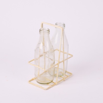 A Pair Of Vintage Milk Bottles And Carrier