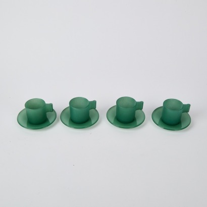 A Set of Four Glass Teacups and Saucers