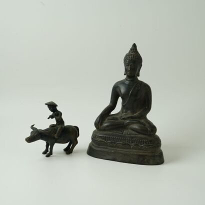 A Buddha Statue and A Buffalo Ornament