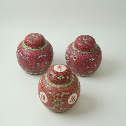 A Set of Three Chinese 20th Century Red-ground Famille-rose Lidded Jars