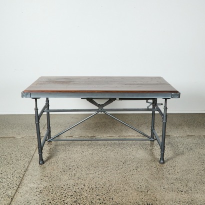 An Industrial Table with Metal Base and Height Adjustable Oak Top