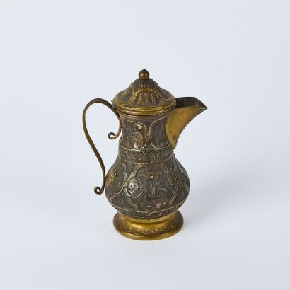A Copper Alloy Miniature Jug with Raised Floral Design