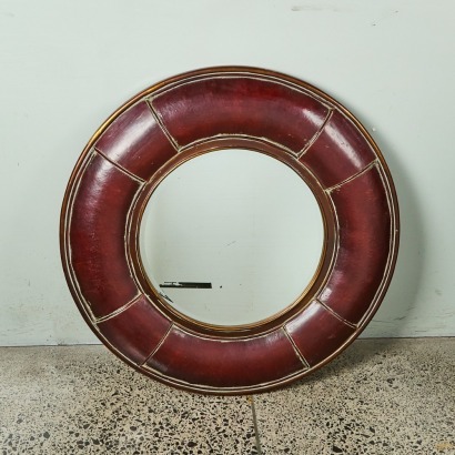 A Handcrafted Large Circular Wall Mirror with Beveled Glass and Brass Trim Accents