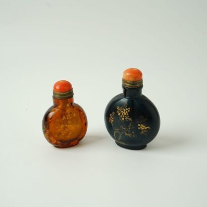 A Chinese Purple Glass Gilt-decorated Snuff Bottle AND An Amber Glass Snuff Bottle