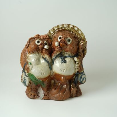 A Porcelain Cartoon-style Racoon Dog Ornament