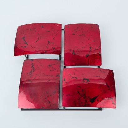 A Minimal Metal Wall Feature In Red Enamel