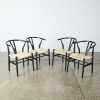 A Set of Four Black Wishbone Beech Y Replica Dining Chairs