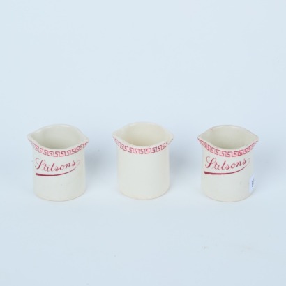 A Set of Three Monogram Stilsons Cream Jugs