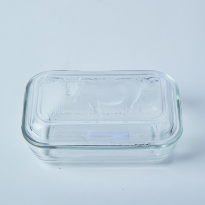 A Luminarc Butter Dish With Cow