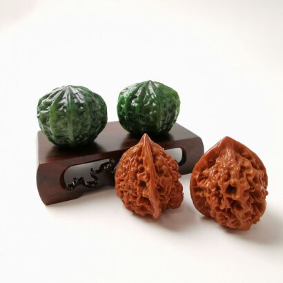 A Pair of Chinese Spinach-Green Jade Walnuts AND A Pair of Aged Walnuts