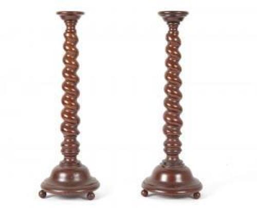 A Pair of Spiral Turned Mahogany Candlesticks