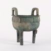 A Chinese Zhou Dynasty Bronze Ding with Taotie Mask Decoration
