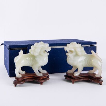 A Pair of Chinese Green Jade Lion Carvings (Original wooden stands)