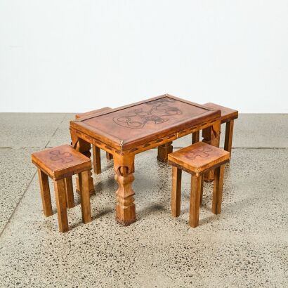 A Leather-Clad Table and Four Stools