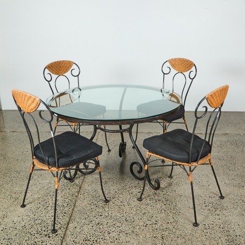 A Wrought Iron and Glass Bistro Table and Four Rattan Chairs