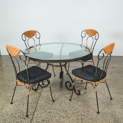A Wrought Iron and Glass Bistro Table and Four Rattan Chairs