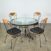 A Wrought Iron and Glass Bistro Table and Four Rattan Chairs