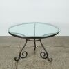A Wrought Iron and Glass Bistro Table and Four Rattan Chairs - 4