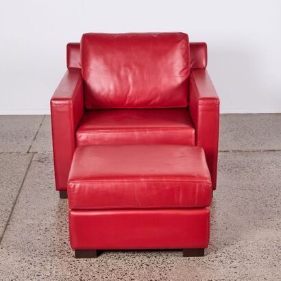 A Red Leather Armchair and Footstool in the Style of Philippe Starck