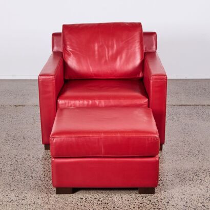 A Red Leather Armchair and Footstool in the Style of Philippe Starck