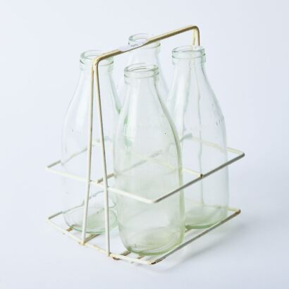 A Set of Four Collectable Vintage Milk Bottles and Carrier