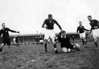 J.M.Taylor (All Black fullback) struggles to gather the ball as J. White (Springbok centre three-quarters) prepares to pounce