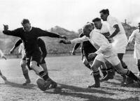 J.A. Gunning (with ball) breaks past Southern forwards. The trio in white are W.J. Mumm, Charles Willocks and A.D. McKenzie