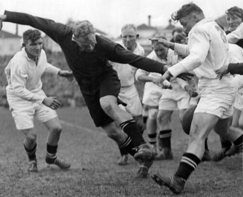 J.A. Gunning (North) burst through scrummage, on the left is J.S. Haig (South half) and behind J.A. Gunning is W.J. Mumm. Forward on the right is J.F. Pegley