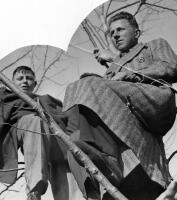 Two spectators watch the match