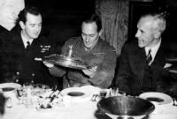 Lieutenant Commander L.D. Wilkinson, D.S.C., son of Sir George explaining plate to C.K. Saxton (Kiwis captain)