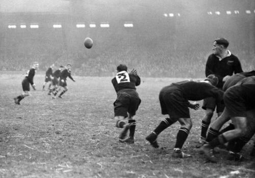 C.K. Saxton (Kiwi captain and half-back) passes ball