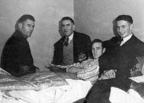 M. Howell (Australia Rugby member) is confined to bed with an injured leg, ith him is Mr. H. Crowe (assistant manager of the team) and T. Allan