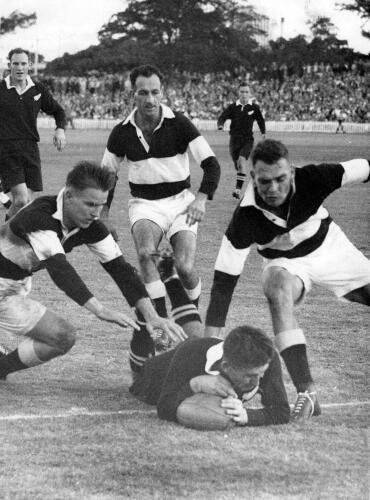 F.R. Allen (All Black captain) scores. Van der Merwe, White, and G. Smit (SA). R.R. Elvidge and L.T. Savage (NZ)