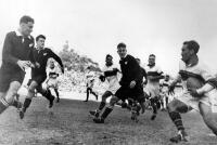 W. Conrad (All Blacks) about to tackle Lawton (wing, N.U.). All Blacks from left: I.J. Botting, D.L. Johnston and P.J. Knowles