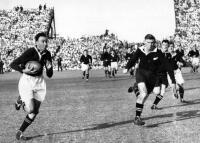 M.P. Goddard (NZ - left) & W.A. Meates ( NZ - right) try to chase down Springboks player F. Duvenage (left)