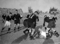 W.A. Meates, Number 3 (NZ - Otago) tackles a South African as Number 11 J.G. Simpson (NZ - Auckland) looks on