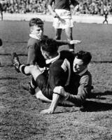 H.J. Solomon & C.T. Burke (Australians) pin down V.D. Bevan (New Zealand half-back)