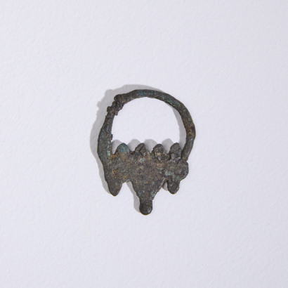 An Egyptian bronze earring