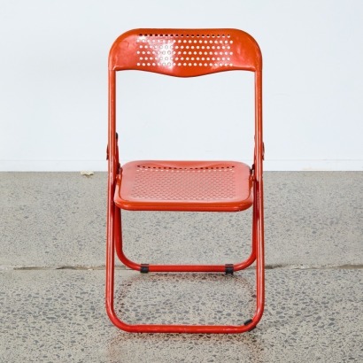 A Red Perforated Metal Folding Chair