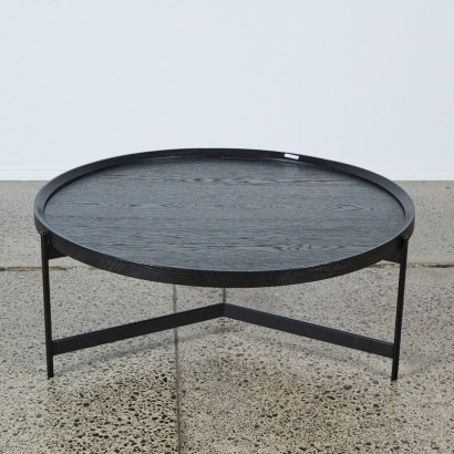 A Small Round Coffee Table on Three Legs