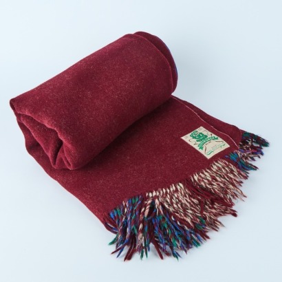 An Onehunga Woollen Mills 'Green Tiki' Travel Rug