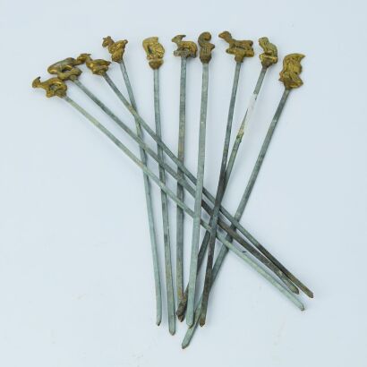 A Set of Ten Meat Skewers With Brass Animal Characters