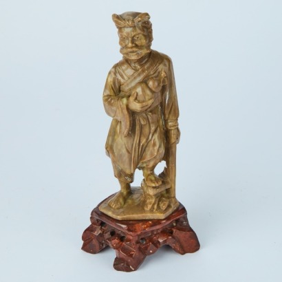 A Hand-Carved Stone Man Statue
